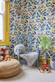 Children's playroom designed by Foxglove House Interiors featuring Array in Dark Indigo wallpaper, with vibrant floral prints that create a serene and playful atmosphere. Photography by Chris Snook.